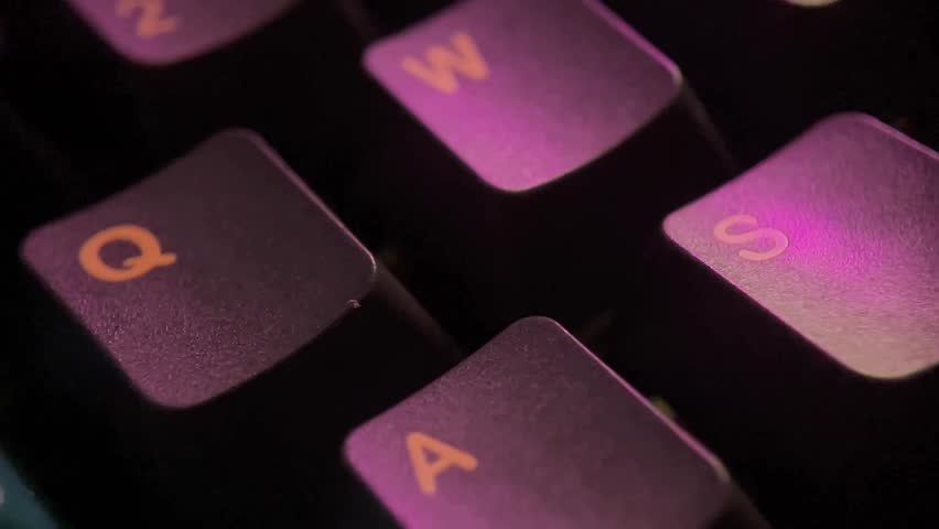 Close-up of keyboard keys with purple lighting