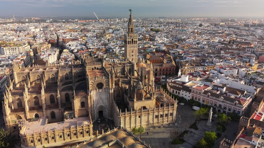 Aerial view of the Seville Cathedral and Giralda tower at sunrise, panoramic shot of the historic city center in Seville, Spain. Historic cityscape of Seville