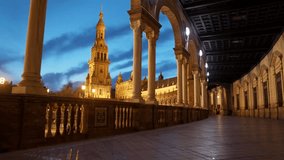 Night view of Plaza de Espana in Seville through gallery of columns, illuminated landmark under blue twilight sky. Plaza de Espana during blue hour in Seville - Powered by Shutterstock - Get 15% off with code: PIKWIZARD15