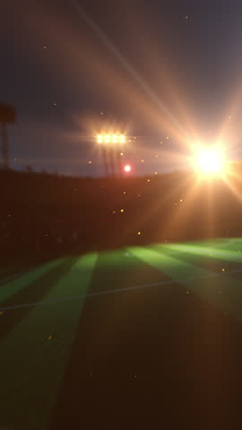 Soccer ball flying over green football pitch.
