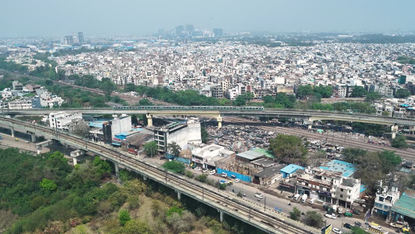 Aerial view of delhi metro passing through dense area in new delhi