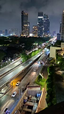 Nighttime Bangkok Cityscape skyline with busy streets of cars, Thailand Capital City, Skyscraper Downtown, Urban Metropolitan, Panning Panorama Shot,  Timelapse Shot