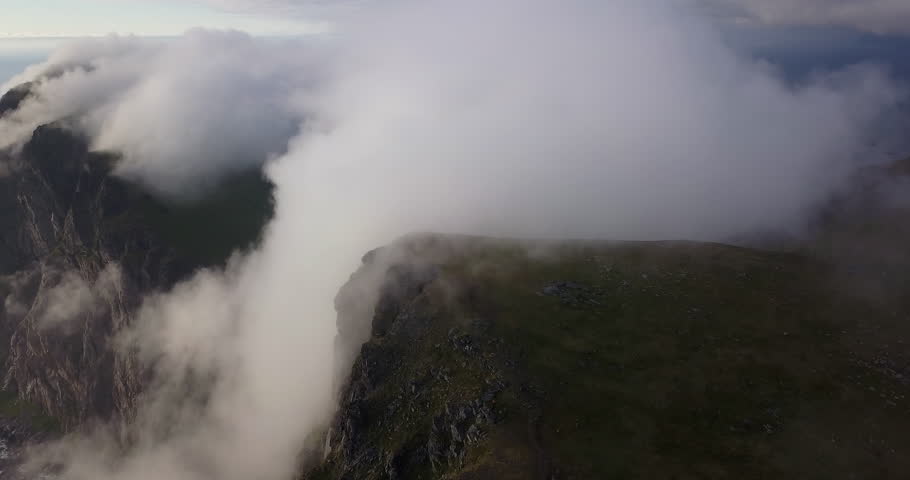 Clouds rolling over mountain ridge in Lofoten Islands Norway