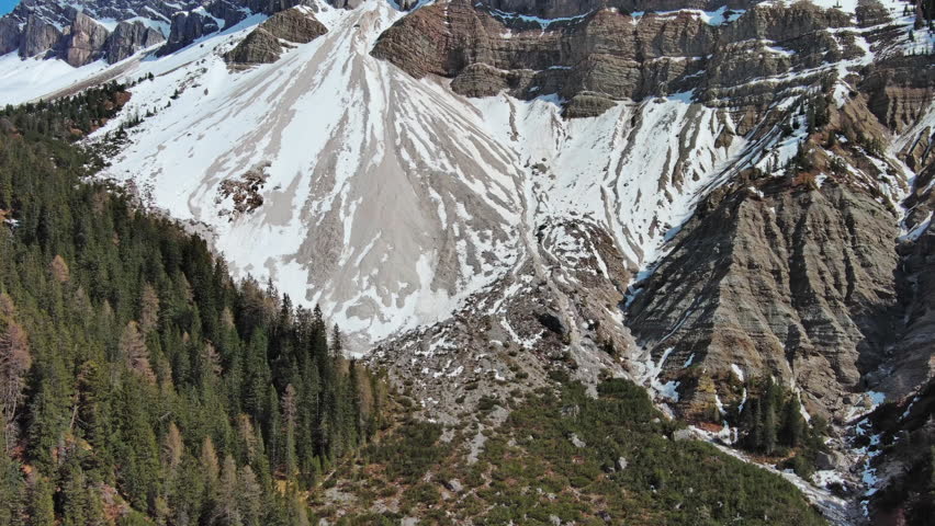 Aerial view of majestic rocky mountains in snow Alps, Dolomites, Italy, 4k