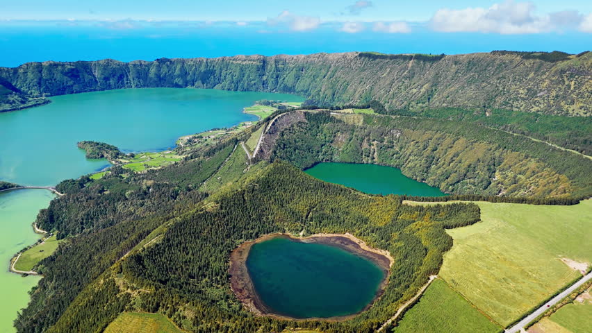 Dual crater lakes inside large volcanic caldera at Sete Cidades on Sao Miguel Island, drone footage