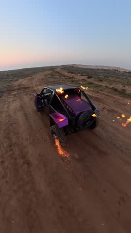 A buggy with flamethrowers on its roof drives through the steppe.