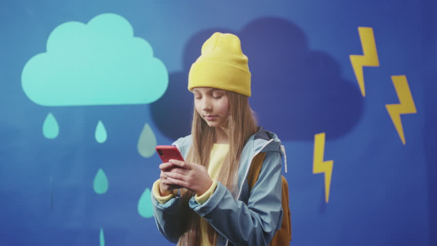 Young person viewing forecast against storm backdrop, Adolescent using mobile to view weather while waiting