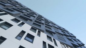 Diagonal perspective of modern apartment building facade with clean geometric window composition. Contemporary architectural background suitable for corporate, technology and real estate themes. - Powered by Shutterstock - Get 15% off with code: PIKWIZARD15