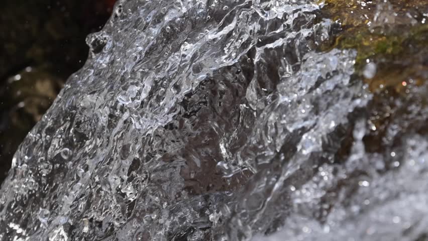 Crystal Clear Stream Water Flowing Over Rocks Macro