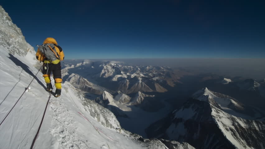 Mountaineer with professional equipment climbing on the world