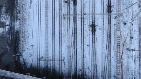 Vertical Aerial Retreat over Snowy Rail Tracks