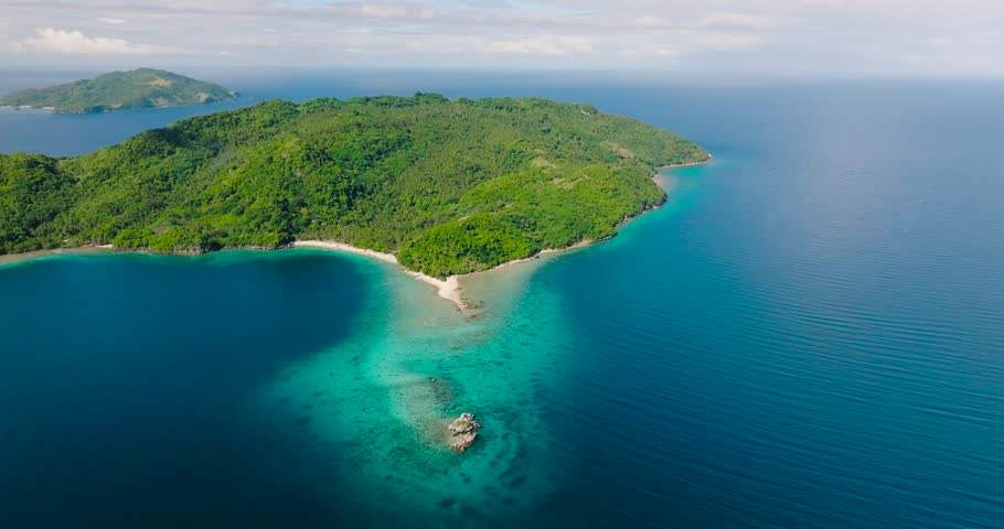 Top view of Blue sea and Alad Island with small white beach. Romblon, Philippines.