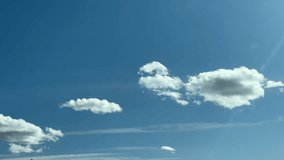 Bright blue sky filled with scattered white cumulus clouds drifting slowly across open atmosphere, creating a peaceful and expansive cloudscape scene ideal for nature backgrounds, weather concepts, and outdoor themes with soft natural light and calming visual texture in a wide unobstructed sky environment - Powered by Shutterstock - Get 15% off with code: PIKWIZARD15