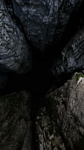 A drone rises from the deep, dark abyss of Nikolina Jama in Montenegro, the deepest karst ravine in the country at 188 meters