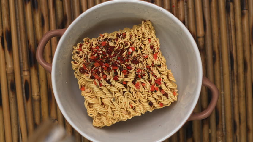 Cooking Chinese Food, Pouring Hot Water. Instant Noodles With Dry Vegetables in Bowl. Macro of Ramen Soup. Rotation