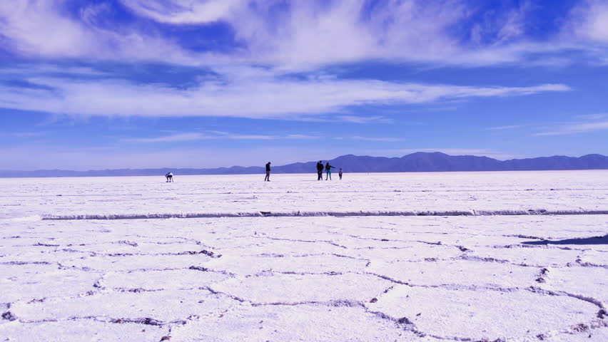 Woman in Colorful Outfit Walking Across Salinas Grandes Salt Flats, Jujuy, Northern Argentina - 4K