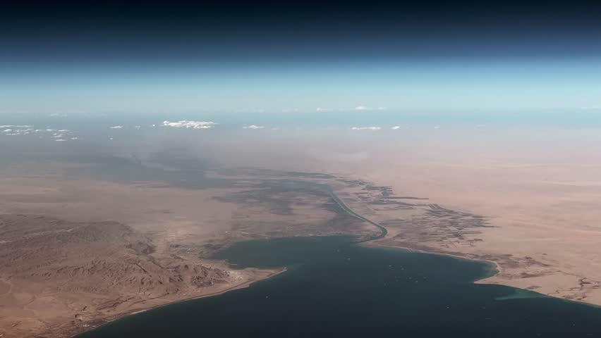 4k aerial video footage, flying across Egyptian Landscape, with Gulf of Suez, (Red Sea) City of Suez and southern entrance of Suez Canal - Sinai Peninsula desert landscape on right site of Canal 