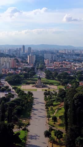 Aerial Drone Panoramic View of São Paulo Skyline from Parque da Independência with Independence Monument and Dense Urban Cityscape, Brazil