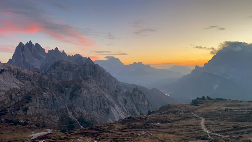 Dolomites in Italy, capturing rugged beauty of the mountains at cloudy sunset.