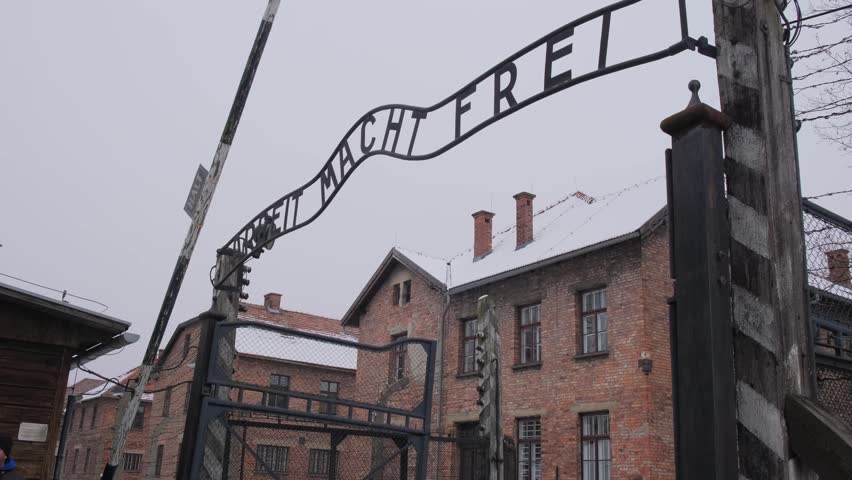 Auschwitz concentration camp gate in winter with snow