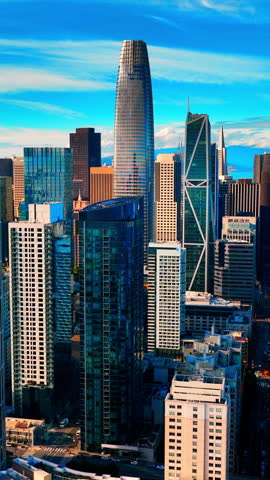 Contemporary high-rise architecture with blue glass facades and geometric designs in a city business district. Aerial view of modern skyscrapers San Francisco. Vertical video.