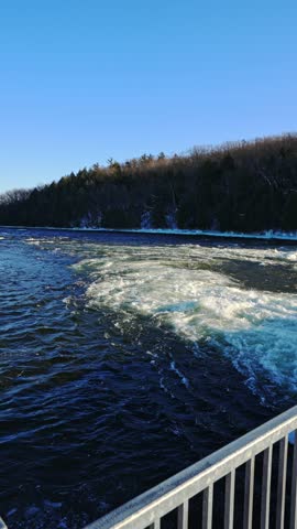 Fast Flowing River in Frankford Ontario Canada During Cold Winter. Vertical Shot.