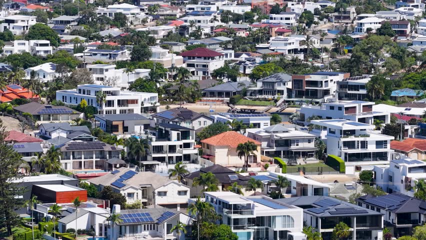 High angle wide shot of dense residential housing and modern apartments under bright daylight