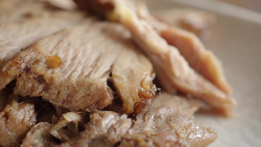 Close up of sliced cooked turkey meat served on plate, detailed texture and appetizing look