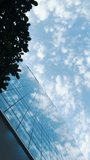 Vertical 4K modern architecture timelapse with glass facade and sky, low angle view video - Powered by Shutterstock - Get 15% off with code: PIKWIZARD15