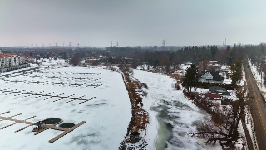 Aerial Drone View Over Newcastle Waterfront in Ontario Canada During Snowy Winter Landscape