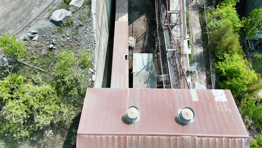Aerially capturing stone being carried upwards across a conveyor belt.
