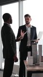 A diverse group of professionals in a modern office setting collaborates around a table displaying architectural models of skyscrapers - Powered by Shutterstock - Get 15% off with code: PIKWIZARD15