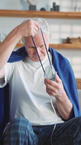 Modern technology in medicine, old man using oxygen machine with nebulizer. Senior sick male person inhaling concentrated oxygen from nebulizer, recovery breathing and relive hypoxia after pneumonia