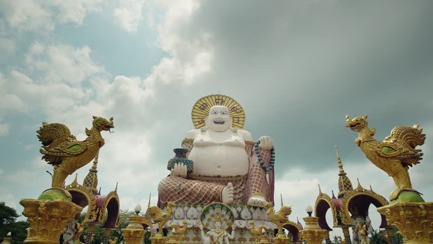 Big Buddha statue surrounded by ornate temple decorations at Wat Plai Laem on Koh Samui island in Thailand.