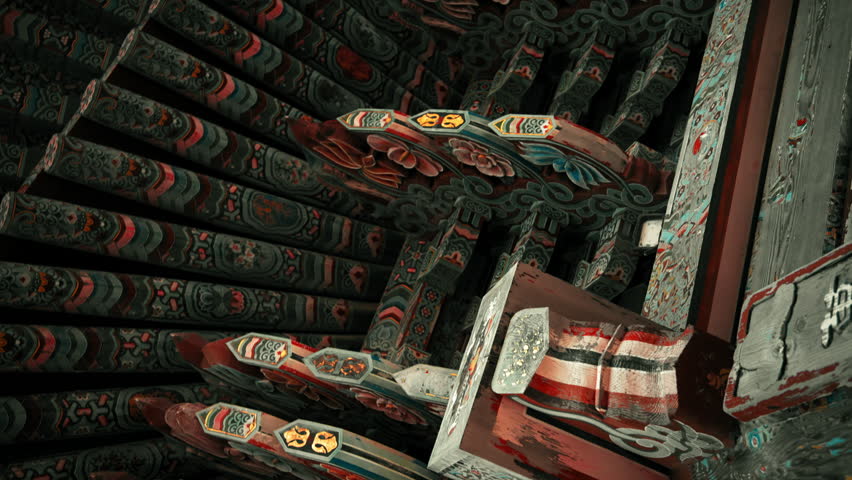 Cinematic rotating shot from below of traditional South Korean Buddhist temple roof revealing intricate dancheong patterns and layered wooden architectural details
