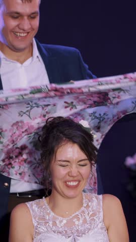 wedding traditions, ceremonies. the groom wears, ties a scarf, a kerchief on the head of the bride, at the end of the wedding. the newlyweds are funny, laughing and happy