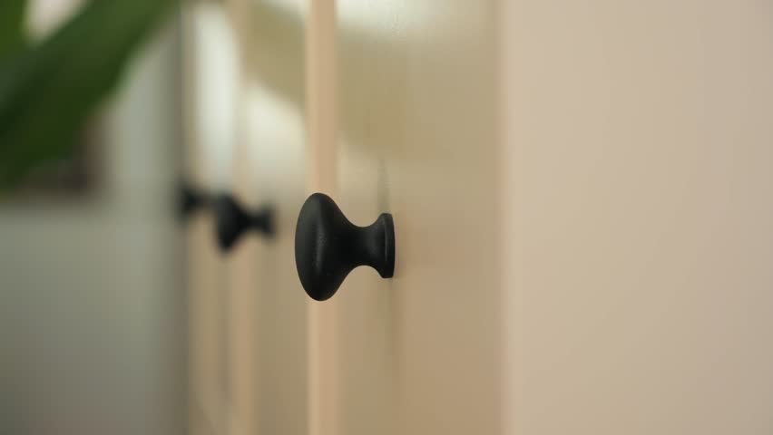 Close-up of a hand opening a drawer. Soft-close drawer. New modern furniture for storing things and documents. . High quality 4k footage