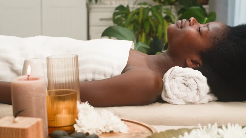 African American Woman Relaxes Serene at a Luxury Spa, Enjoying Wellness and Tranquil Pampering
