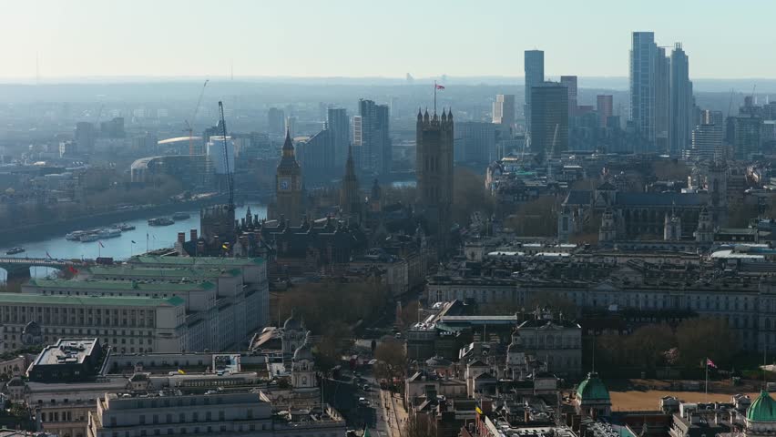 Elevated cityscape of London showing Big Ben and Palace of Westminster, River Thames, modern skyscrapers in the City of London financial district