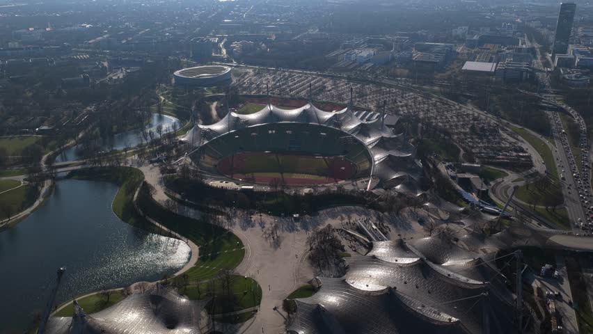 Olympiapark Munich with Olympic Stadium and Olympic Tower, major german urban landmark and city skyline attraction, revealing cityscape of Bavaria's capital from above