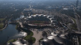 Olympiapark Munich with Olympic Stadium and Olympic Tower, major german urban landmark and city skyline attraction, revealing cityscape of Bavaria's capital from above - Powered by Shutterstock - Get 15% off with code: PIKWIZARD15