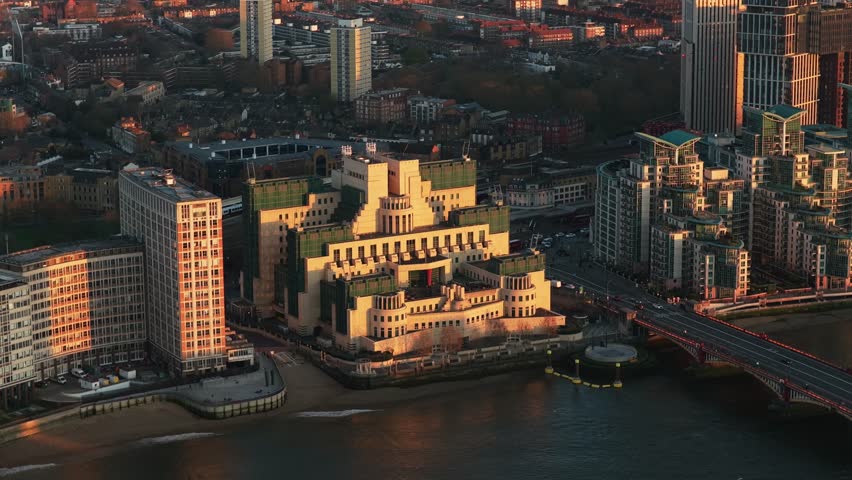 Golden hour illuminating MI6 Building on River Thames with Vauxhall Bridge and London Borough of Lambeth revealing city