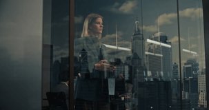 Young Caucasian Businesswoman Stands by a High-rise Office Window, Working on Her Smartphone While City Skyscrapers Reflected in Glass. Startup Finance, Economic Strategy, Leadership, Success. - Powered by Shutterstock - Get 15% off with code: PIKWIZARD15