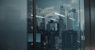 Young Caucasian Businessman in a Gray Suit Stands by the Office Window, Hand on Chin, Focused on Strategy as Reflections Reveal City Skyscrapers, Bright Workspaces, and Successful Colleagues in Motion - Powered by Shutterstock - Get 15% off with code: PIKWIZARD15