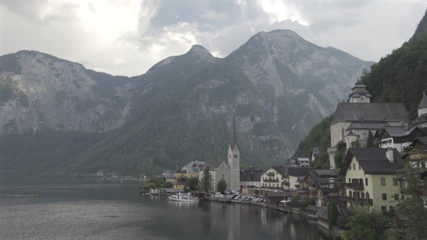 Beautiful church in Hallstatt, Austria, seen from a viewpoint overlooking the serene lake and majestic mountains. Stunning landscape and historic architecture make it a popular travel destination. 