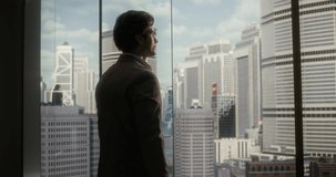 White Businessman in a Taupe Suit Stands by a Floor-to-ceiling Office Window, Thoughtfully Shaping Business Strategy and Startup Goals With Confidence, Ambition, Finance Insight and Success. - Powered by Shutterstock - Get 15% off with code: PIKWIZARD15