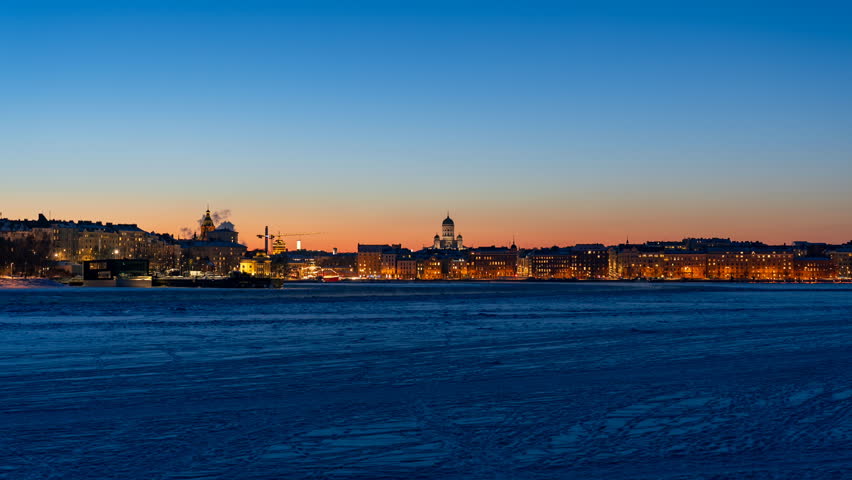 Timelapse of ferry on the way to illuminated Helsinki in winter dusk