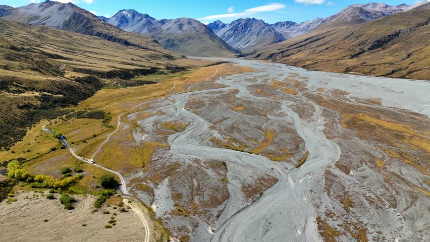 Aerial drone shot of a 4x4 camper driving in New Zealand. The beauty of the South Island near Mount Cook. Idyllic road trip scene across New Zealand’s South Island.