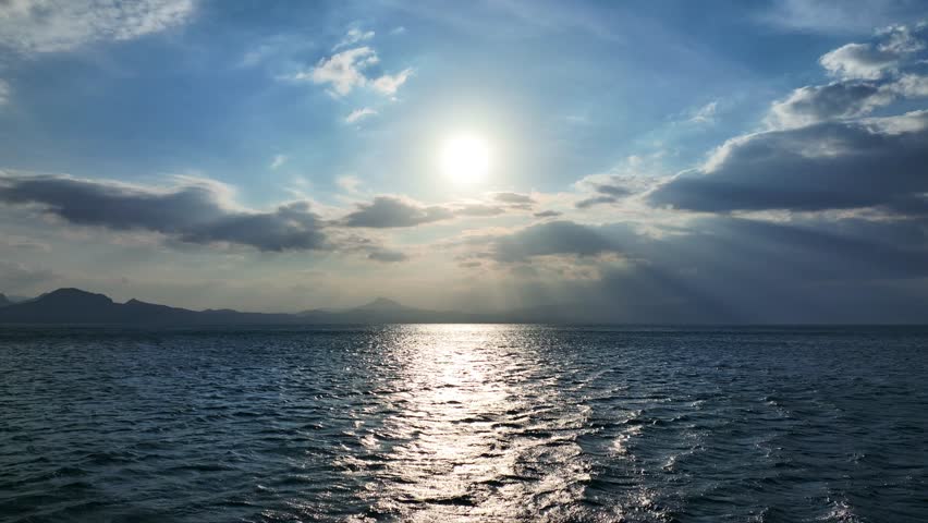 Aerial drone cinematic video of sunset over cloudy open ocean sea with beautiful colors