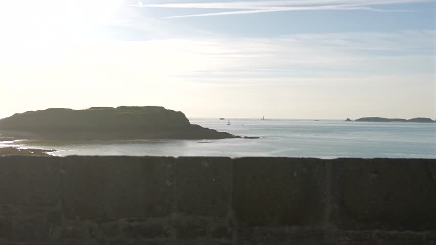 Rocky coastline and calm sea at sunset Saint Malo France